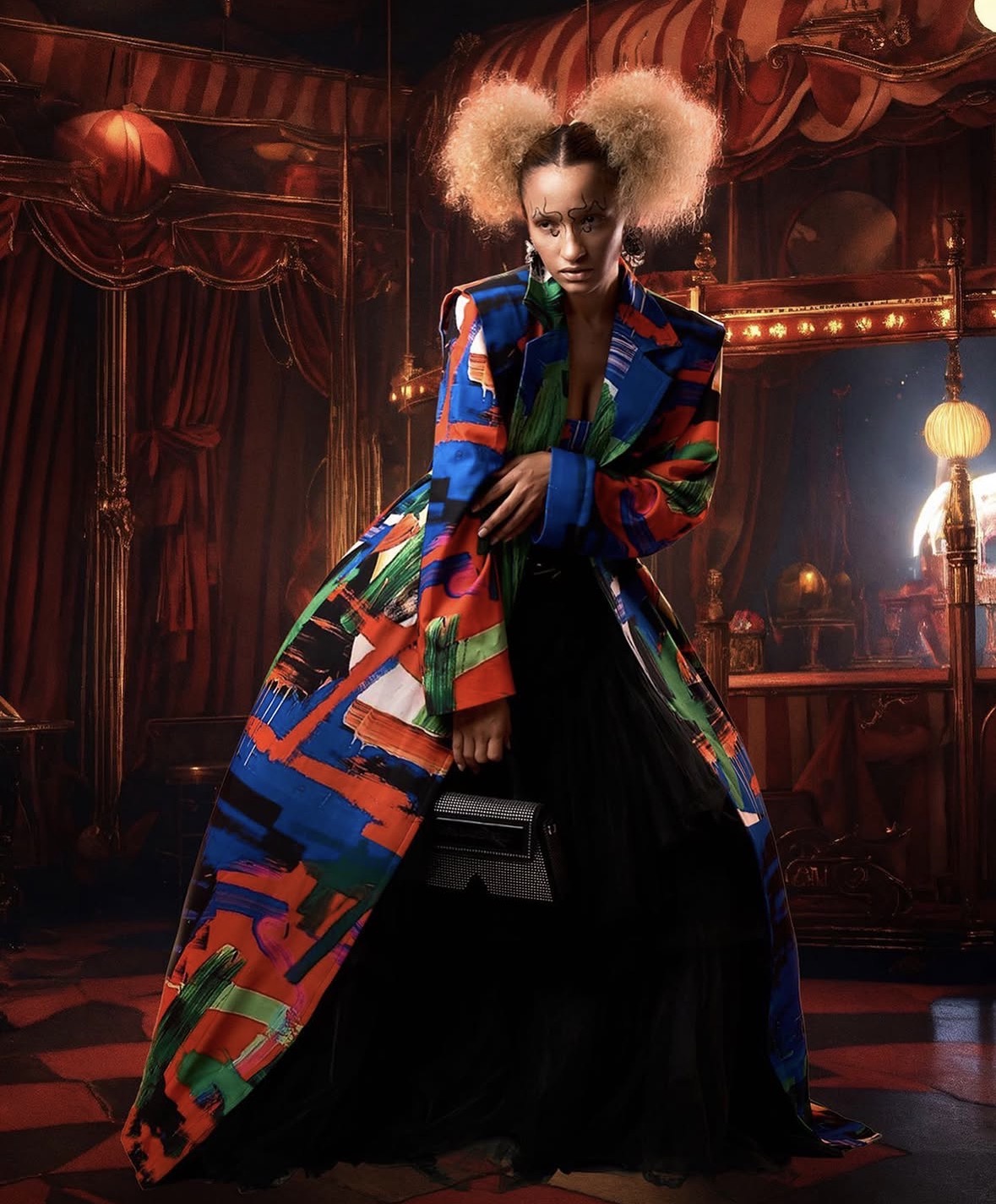 Nalu Rodrigues in a vivid multicoloured coat and black skirt for the Universes editorial.